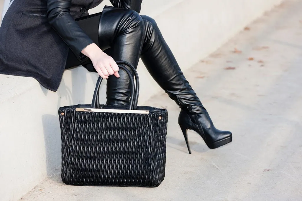 woman wearing boots with a handbag