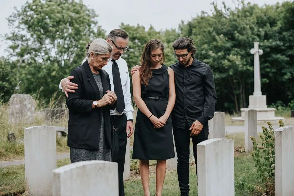 family giving their last goodbyes at the cemetery
