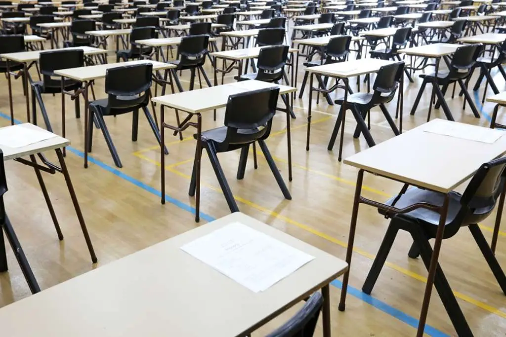 large exam room hall and examination desks tables lined up in rows