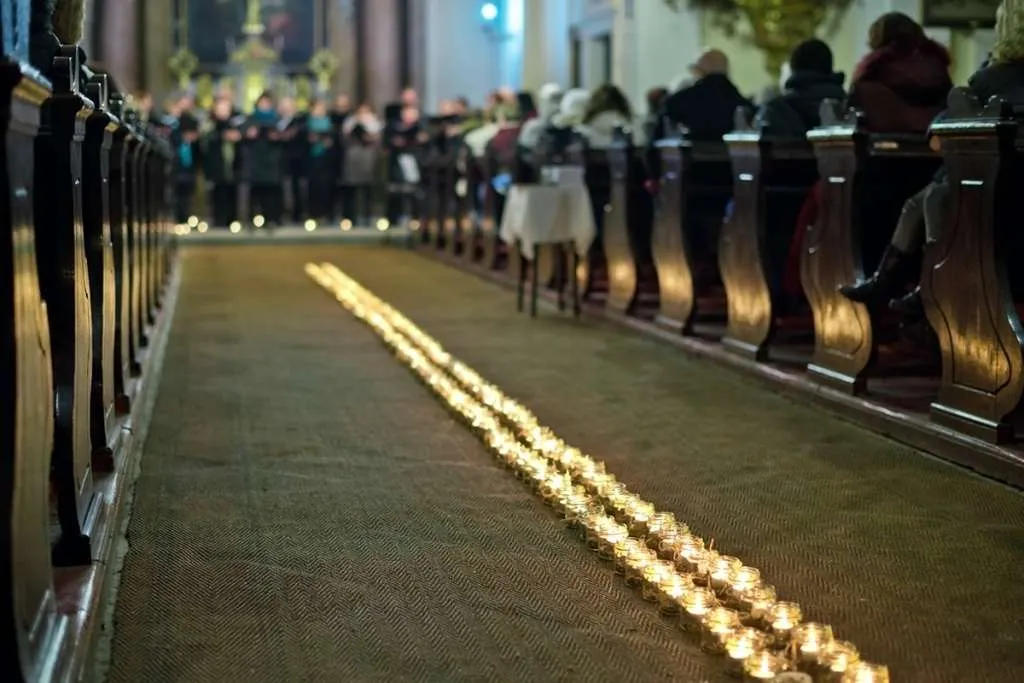 line of flaming candles in catholic funeral