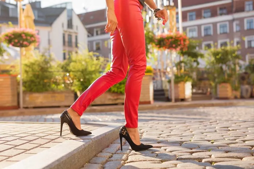 soman walking on the street in red trousers