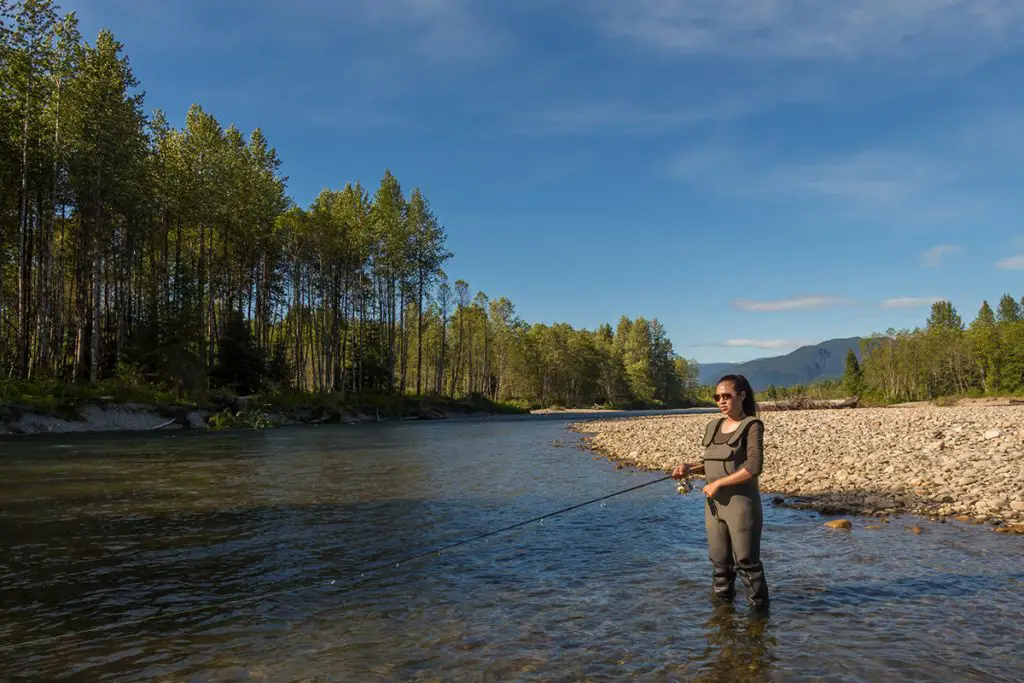 asian woman in waders, fishing