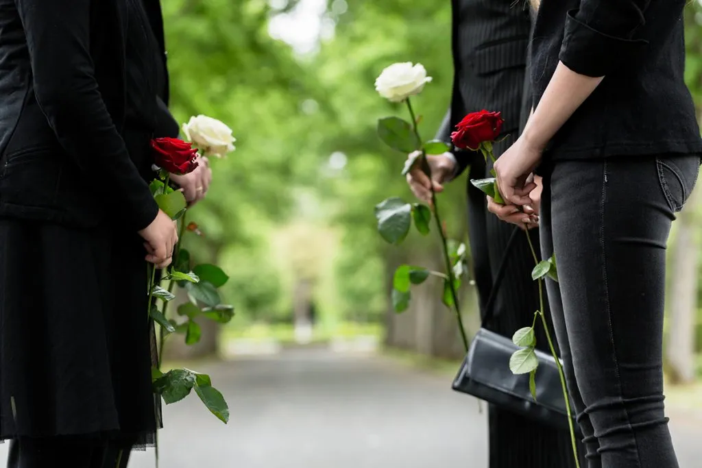 at the funeral, the family formed a guard of honor with roses