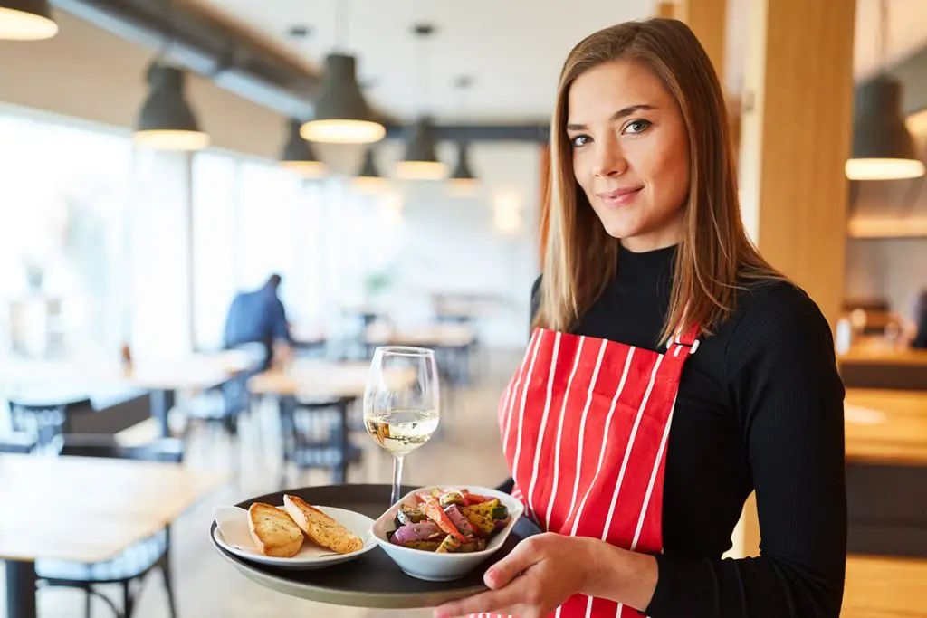 waitress in the restaurant with the food tray