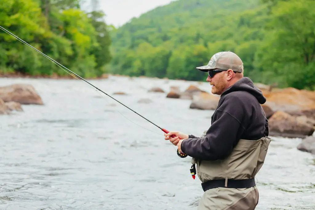 man fly fishing wearing a wader