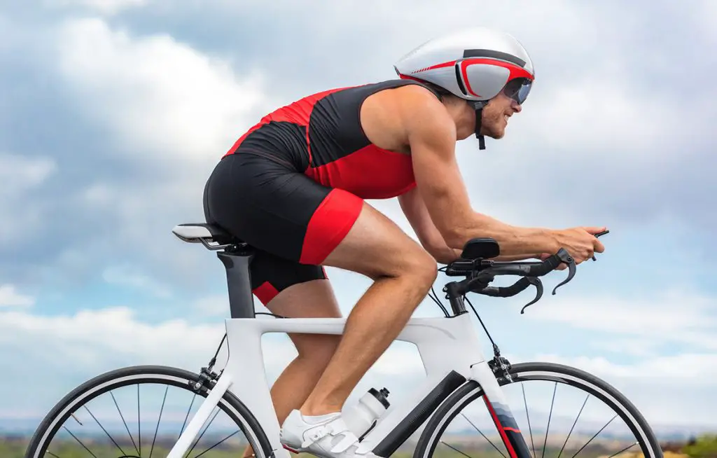 Cycling sport athlete man biking on triathlon bike