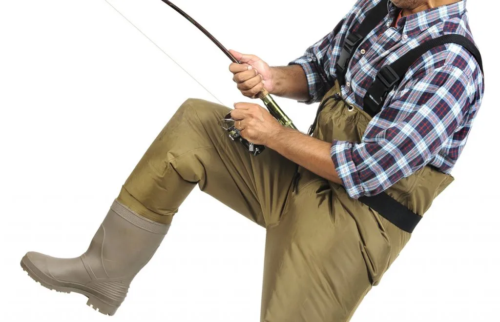 fisherman wearing a wader with a fishing rod