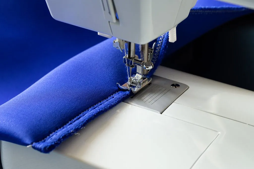 on a white sewing machine sewn product cover of blue neoprene