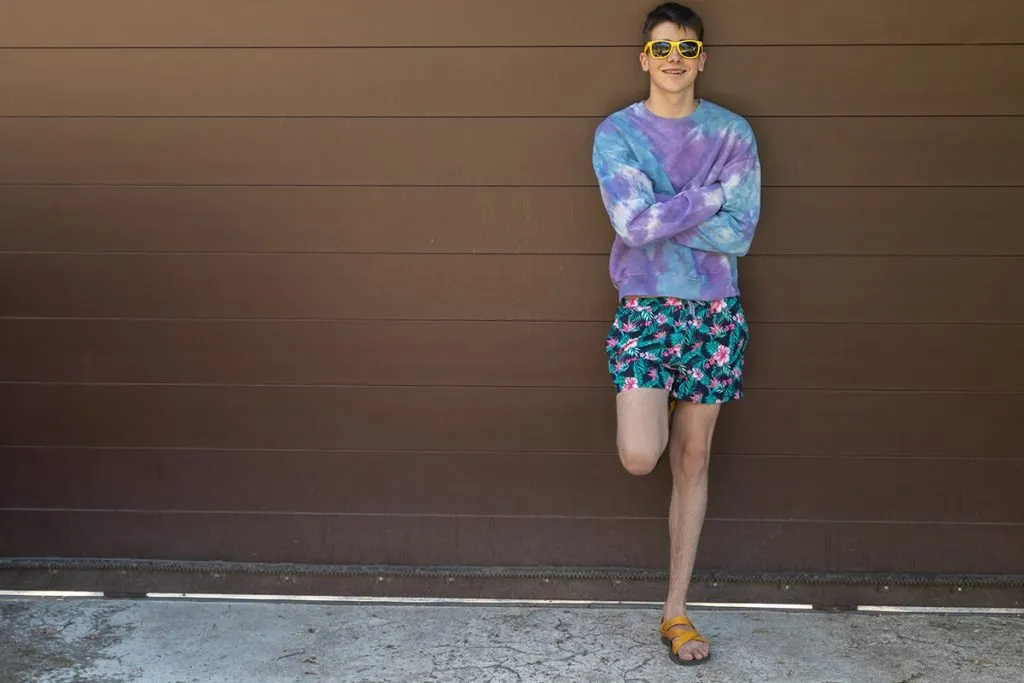 young teenage with sunglasses outdoors