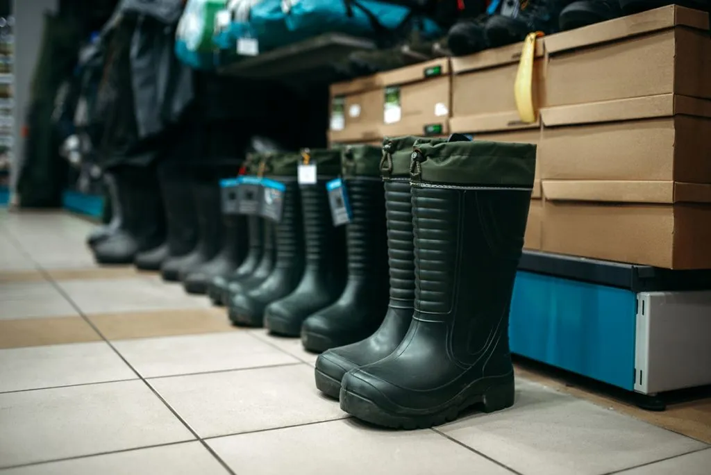 row of rubber boots in fishing shop
