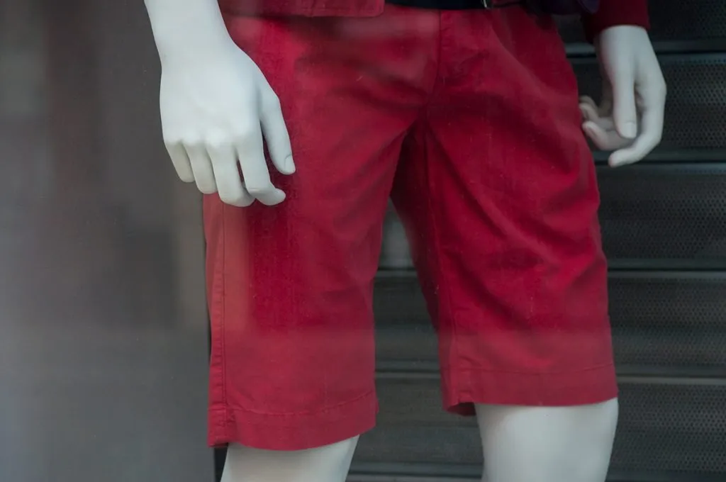 red bermuda short for children on mannequin in fashion store showroom