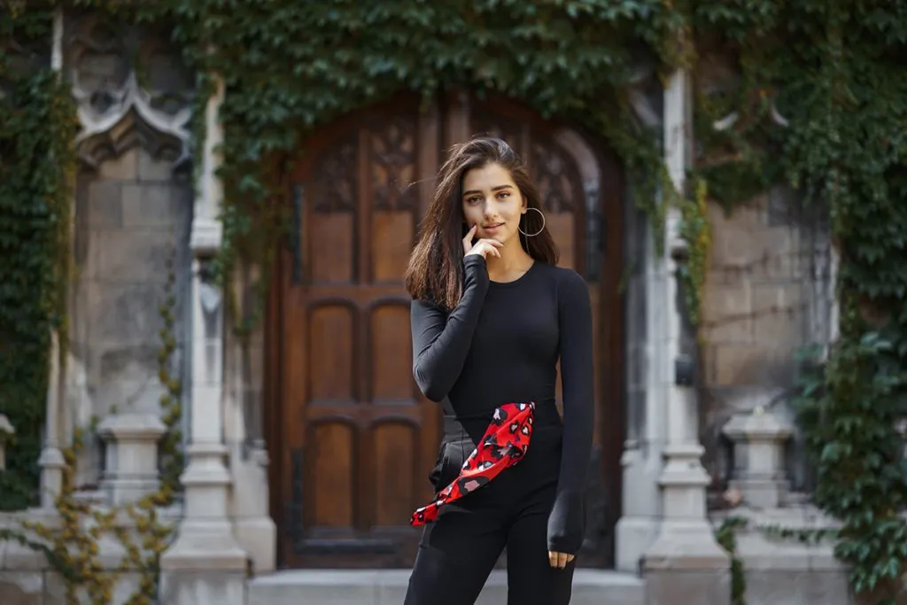 woman standing next to the entance to a church