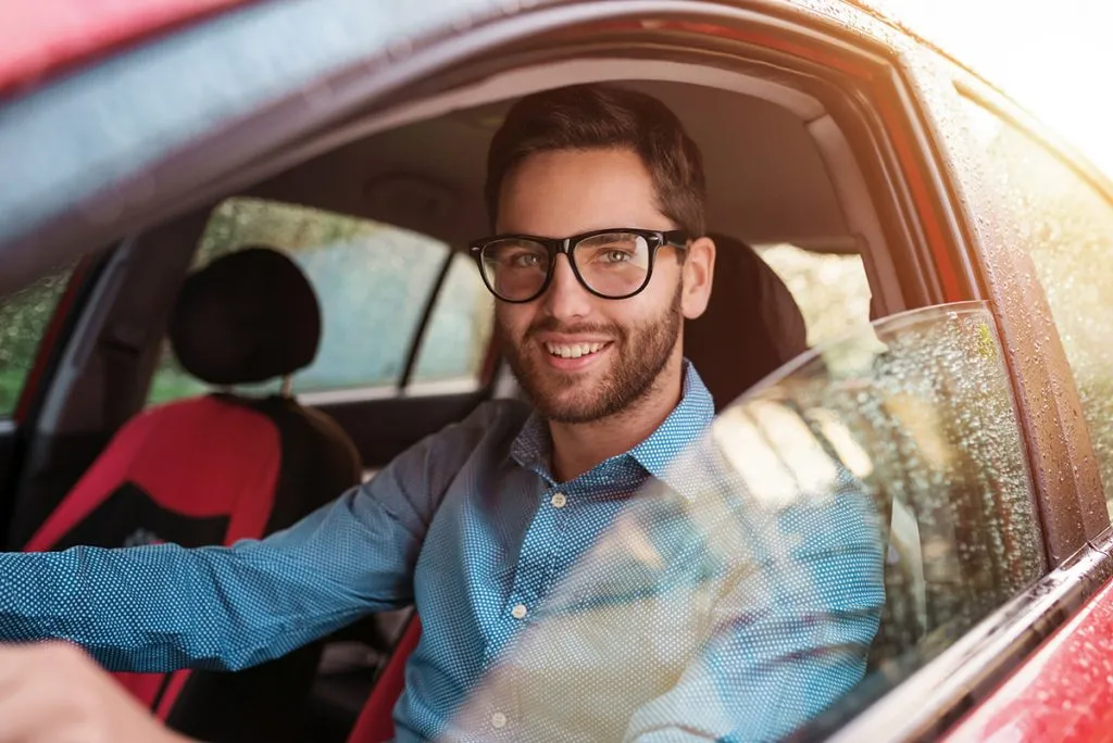 man driving a car