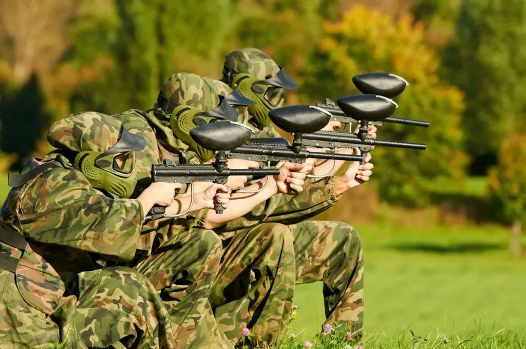 paintball players team aiming markers