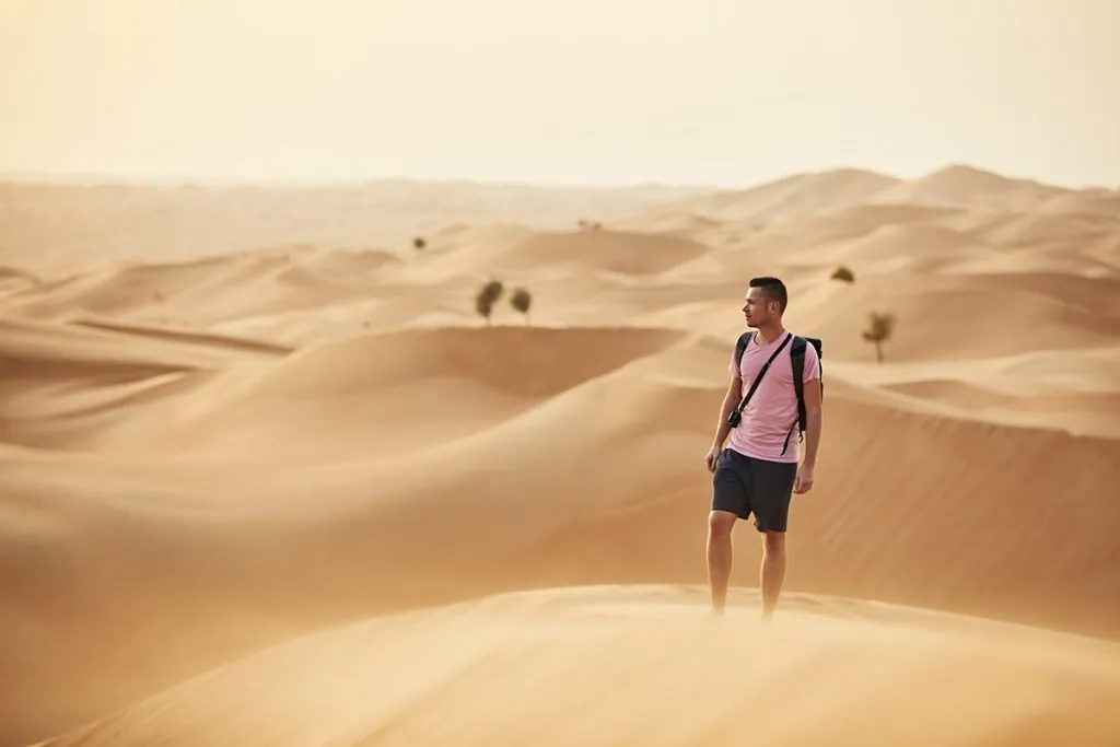 man wears short in desert