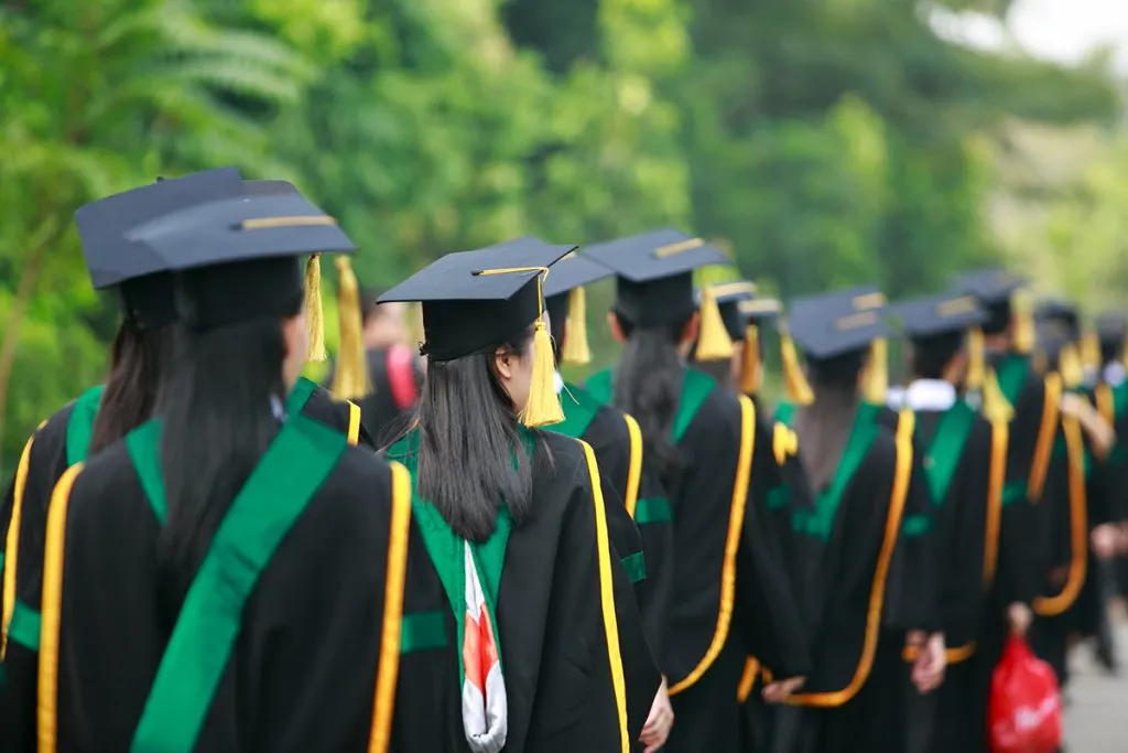 fall in line students wearing graduation gown