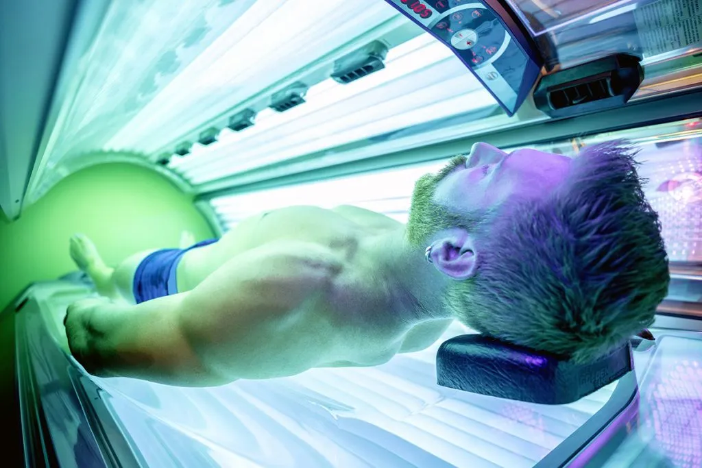man in tanning bed
