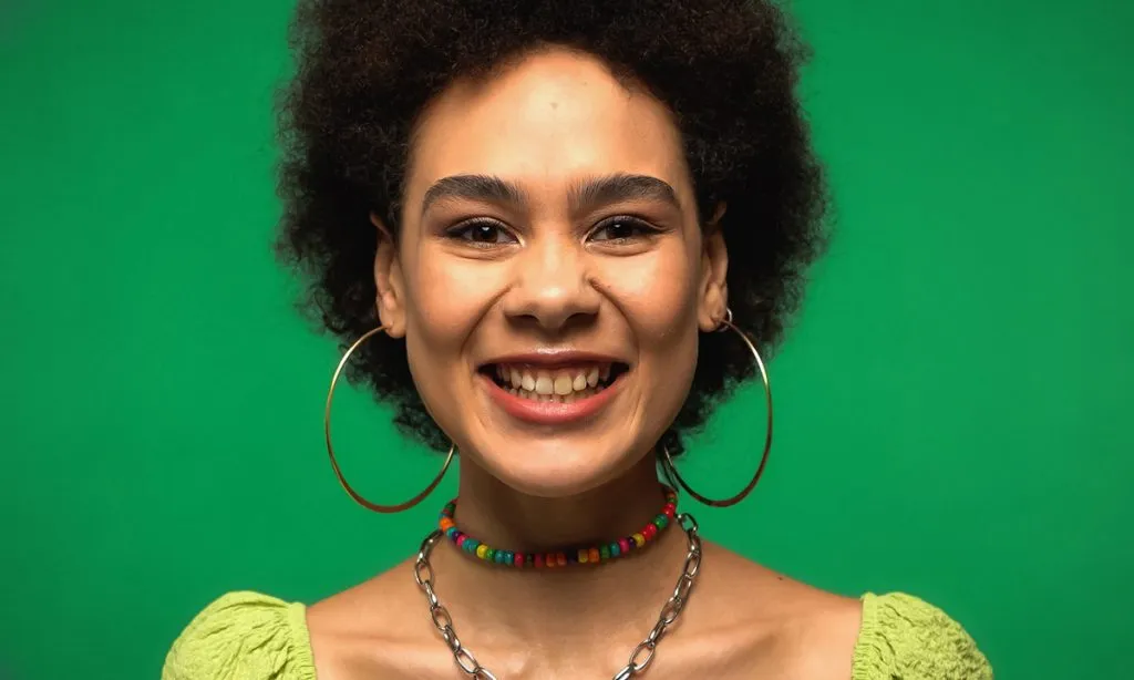 joyful african american woman in hoop earrings