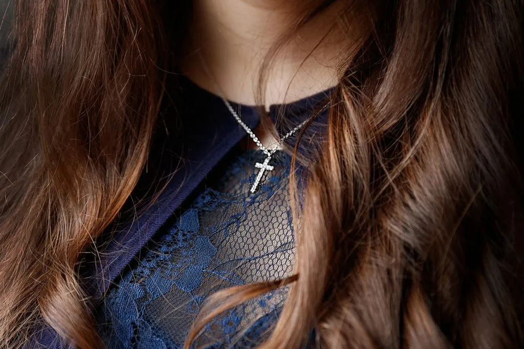 girl wearing crucifix pendant