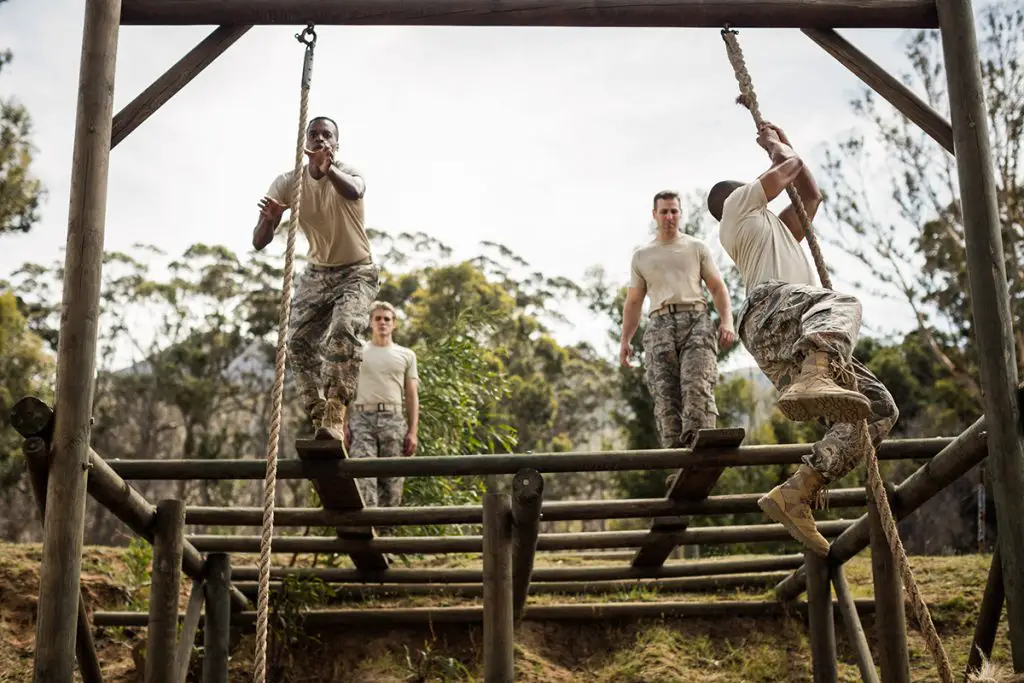 soldiers training rope climbing at boot camp