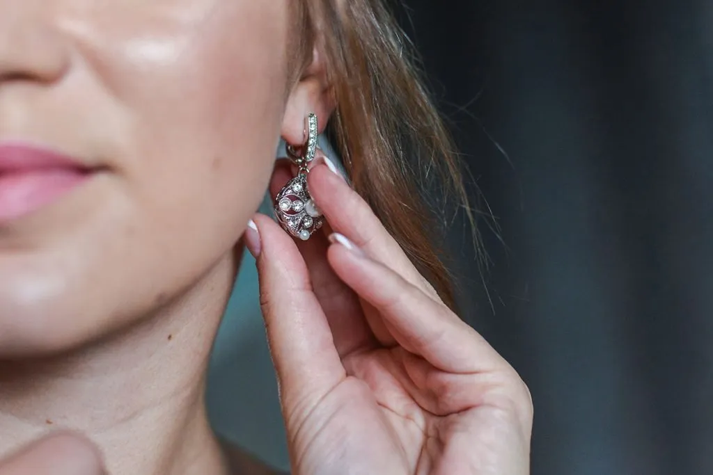 girl wears jewelry in the bathroom