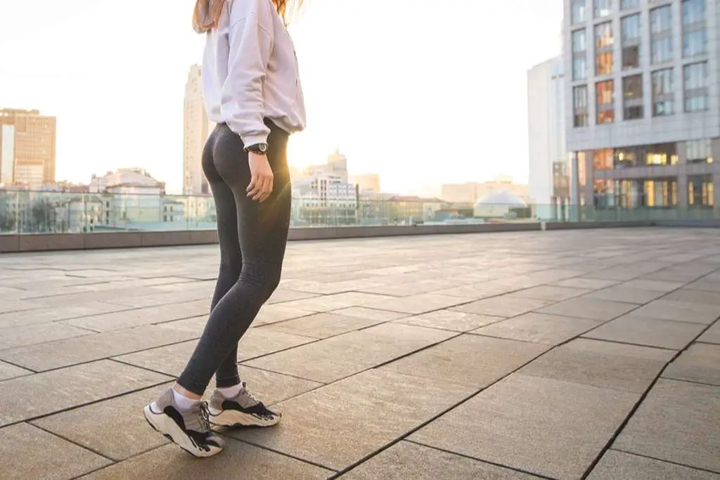 girl's legs in sportswear walking around the city