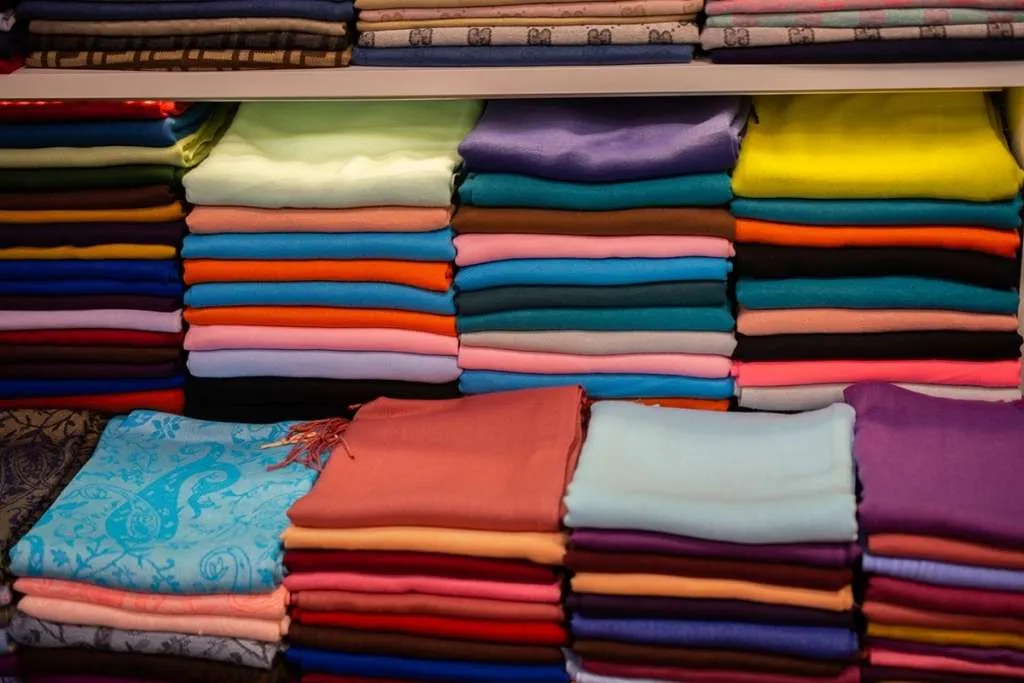 pile of bright multi-colored pieces of fabric in a bazaar