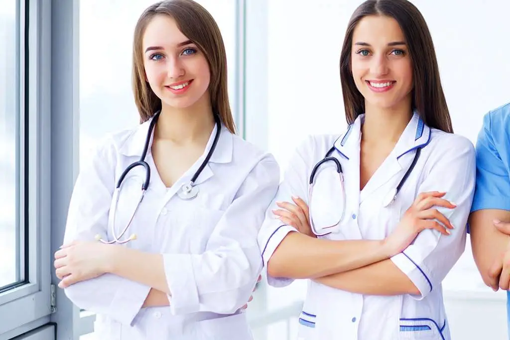 team of medical doctors are smiling while standing in the hospital